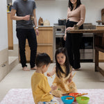 Children eating snacks on a wipeaple minimalist baby play mat in an open living space