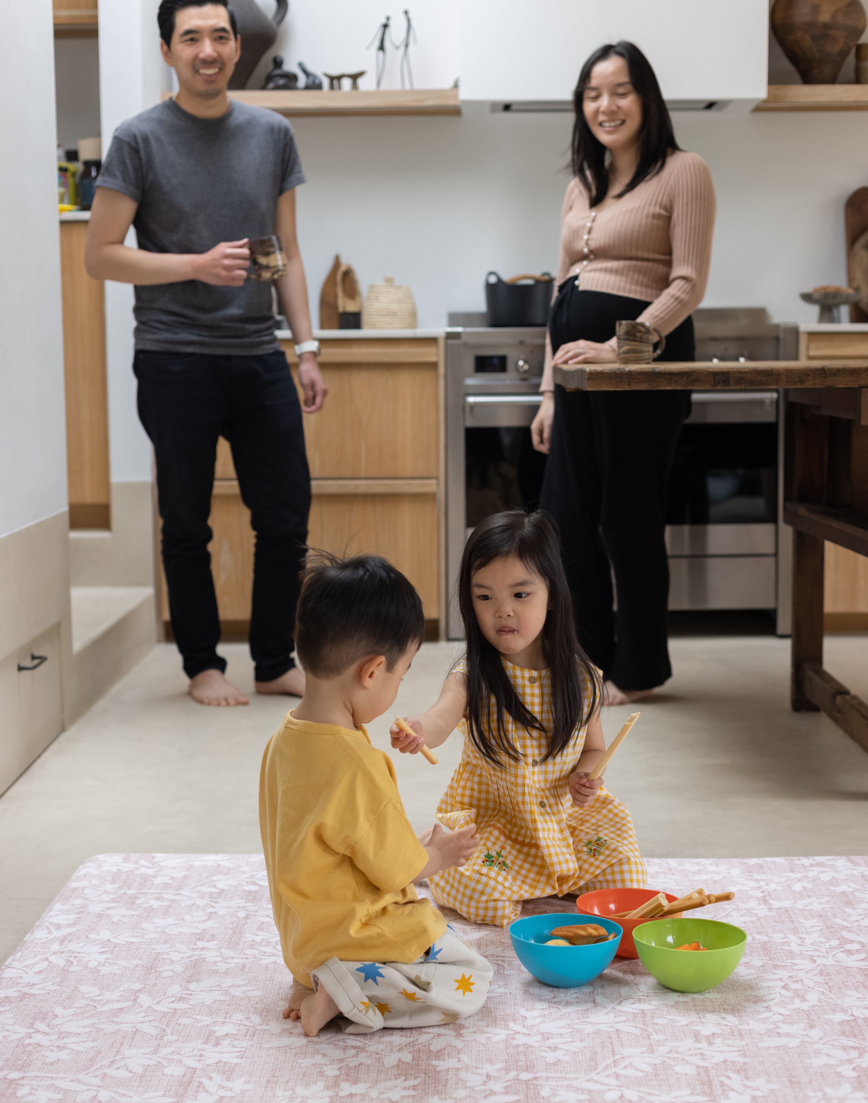 Children eating snacks on a wipeaple minimalist baby play mat in an open living space