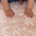 Child crawling on a soft and supportive elegant alternative to colorful play mats