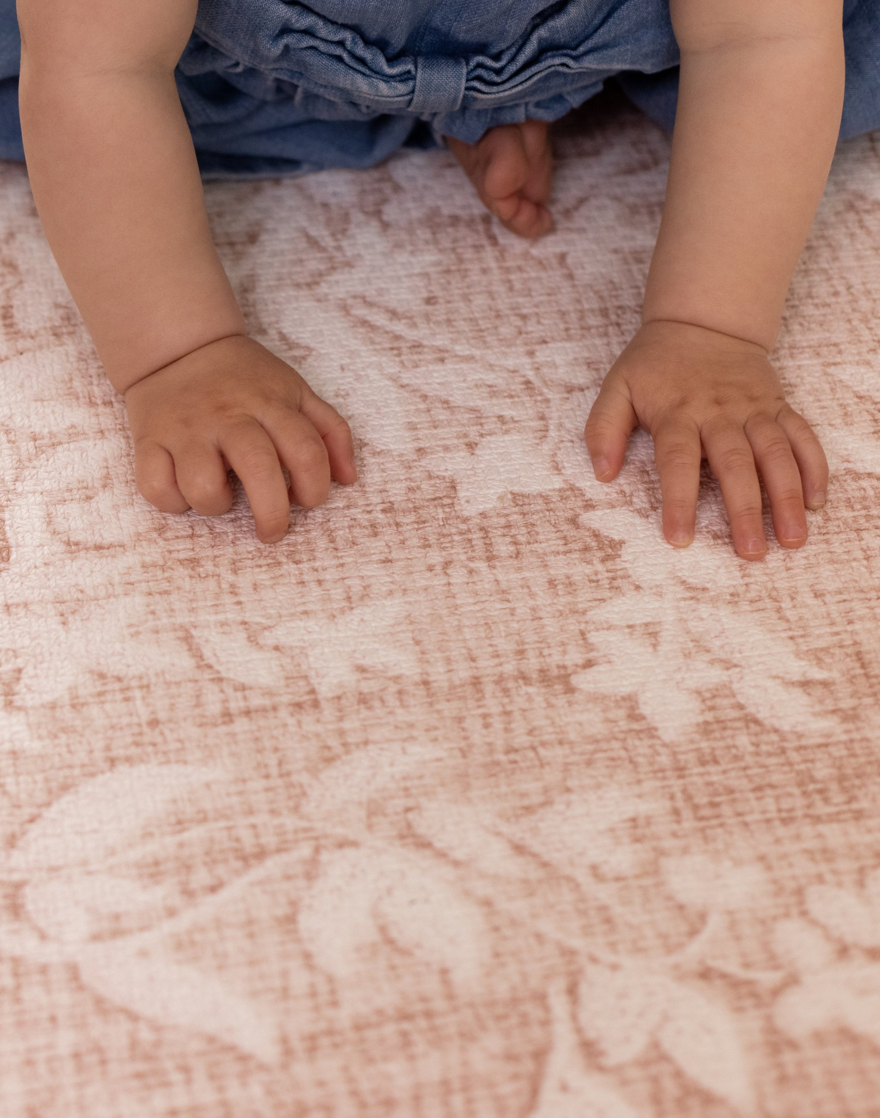 Child crawling on a soft and supportive elegant alternative to colorful play mats