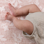 Baby legs on a padded play mat for newborns