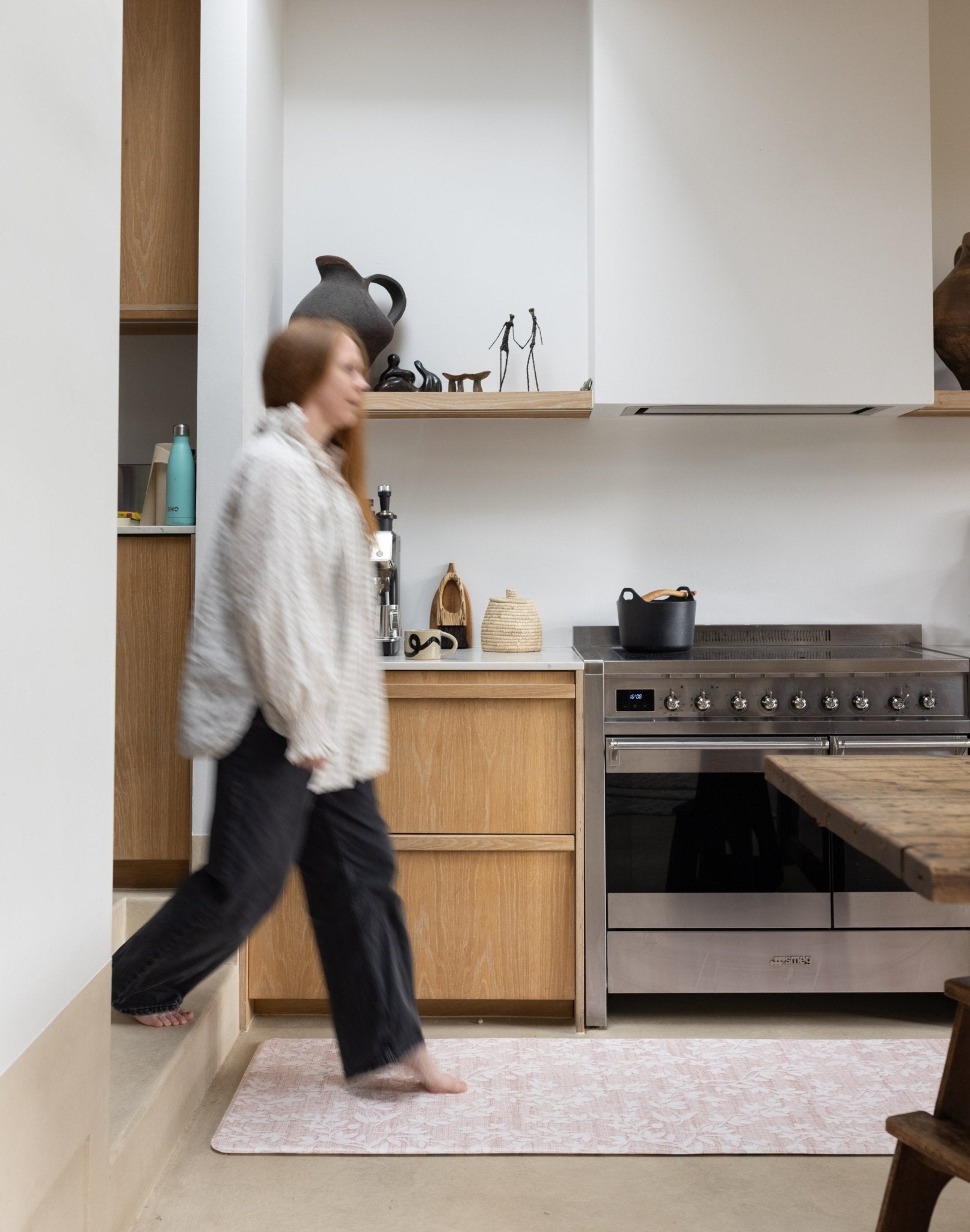 Woman walking on an easy cleaning padded standing kitchen runner mat 