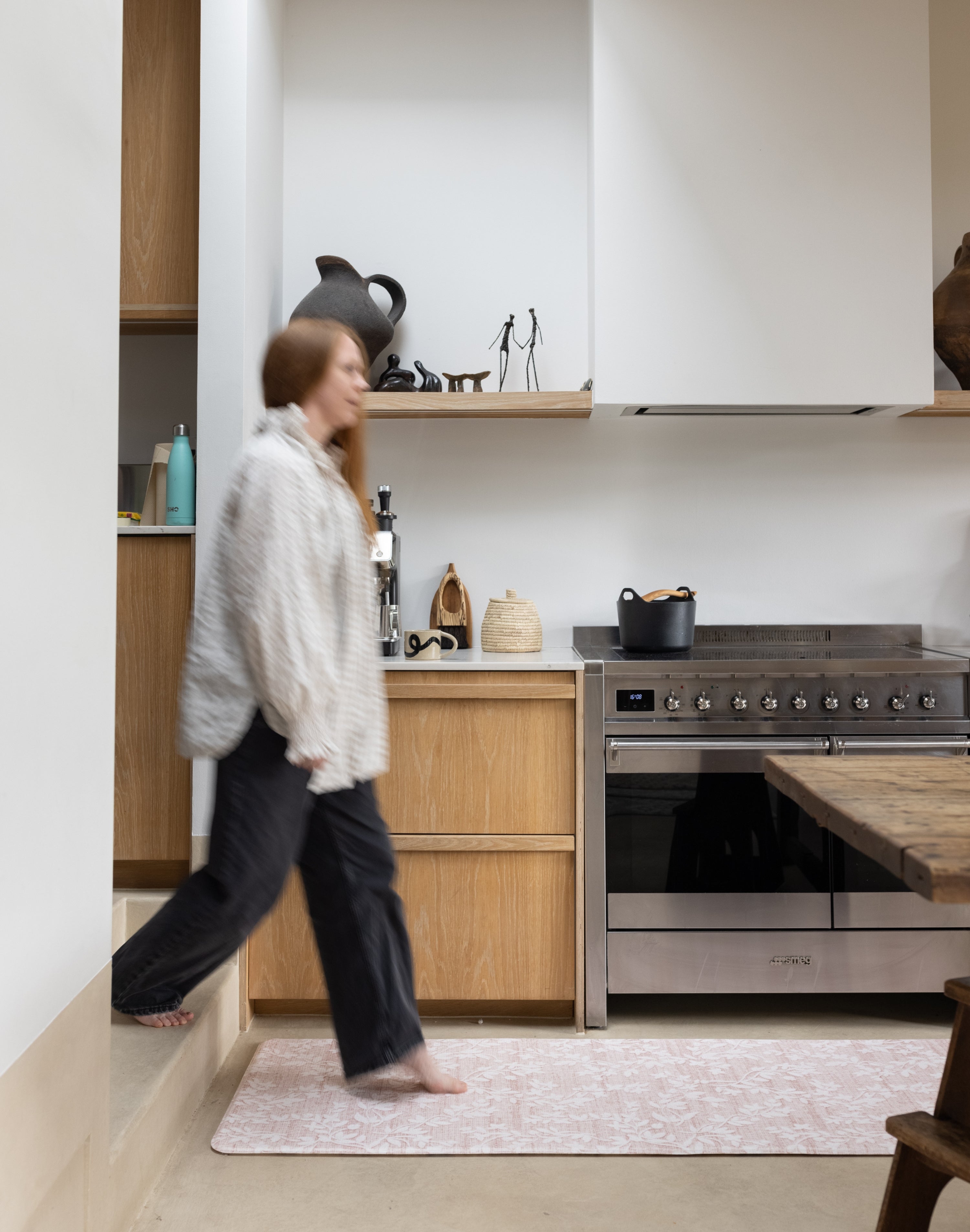 Woman walking on an easy cleaning padded standing kitchen runner mat 