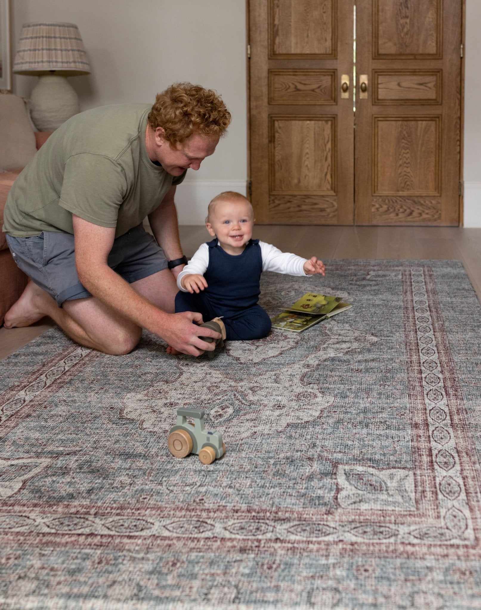 Dad and toddler playing together on Totter + Tumble padded playmat.
