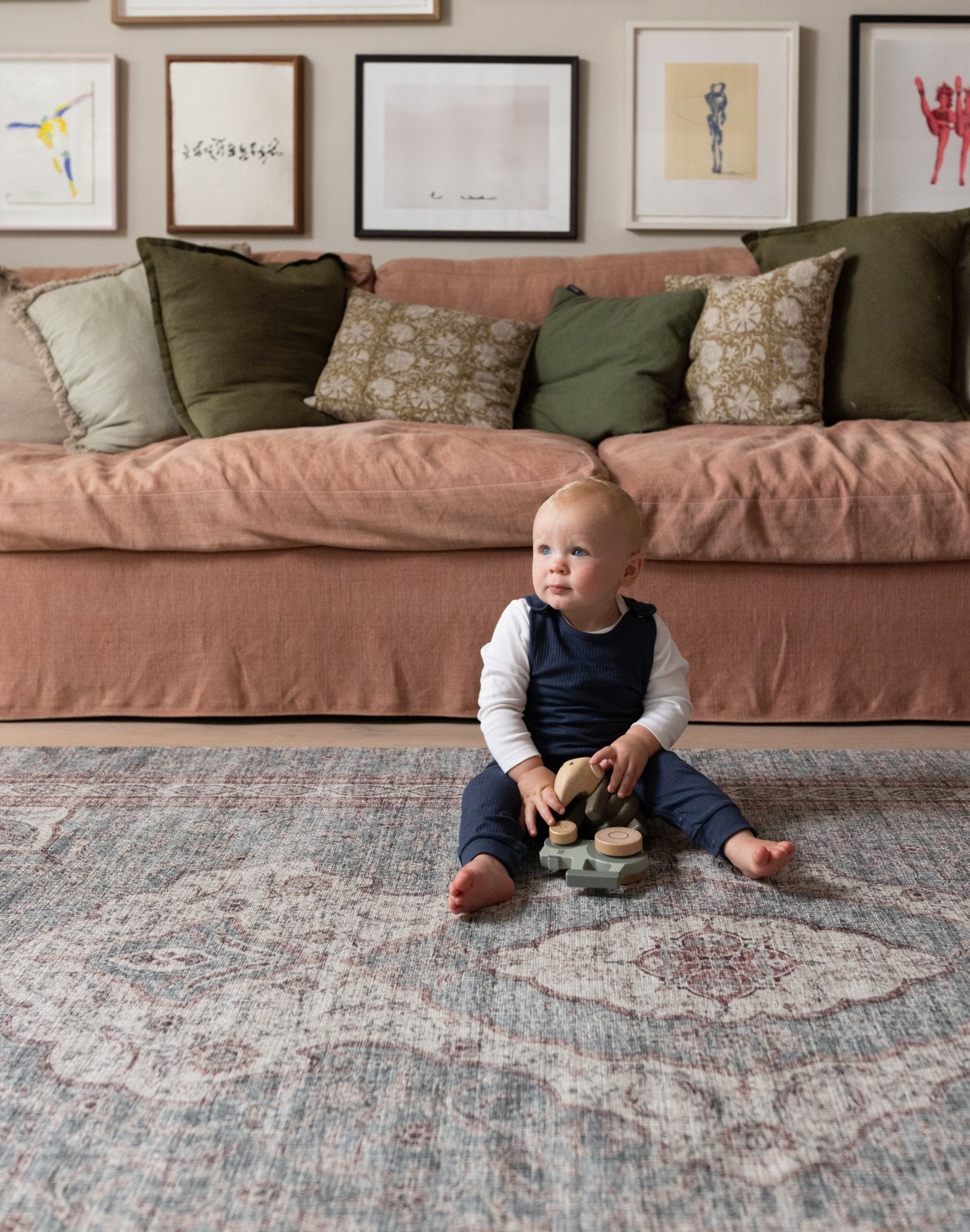 Young child playing on Totter + Tumble soft washable playmat.