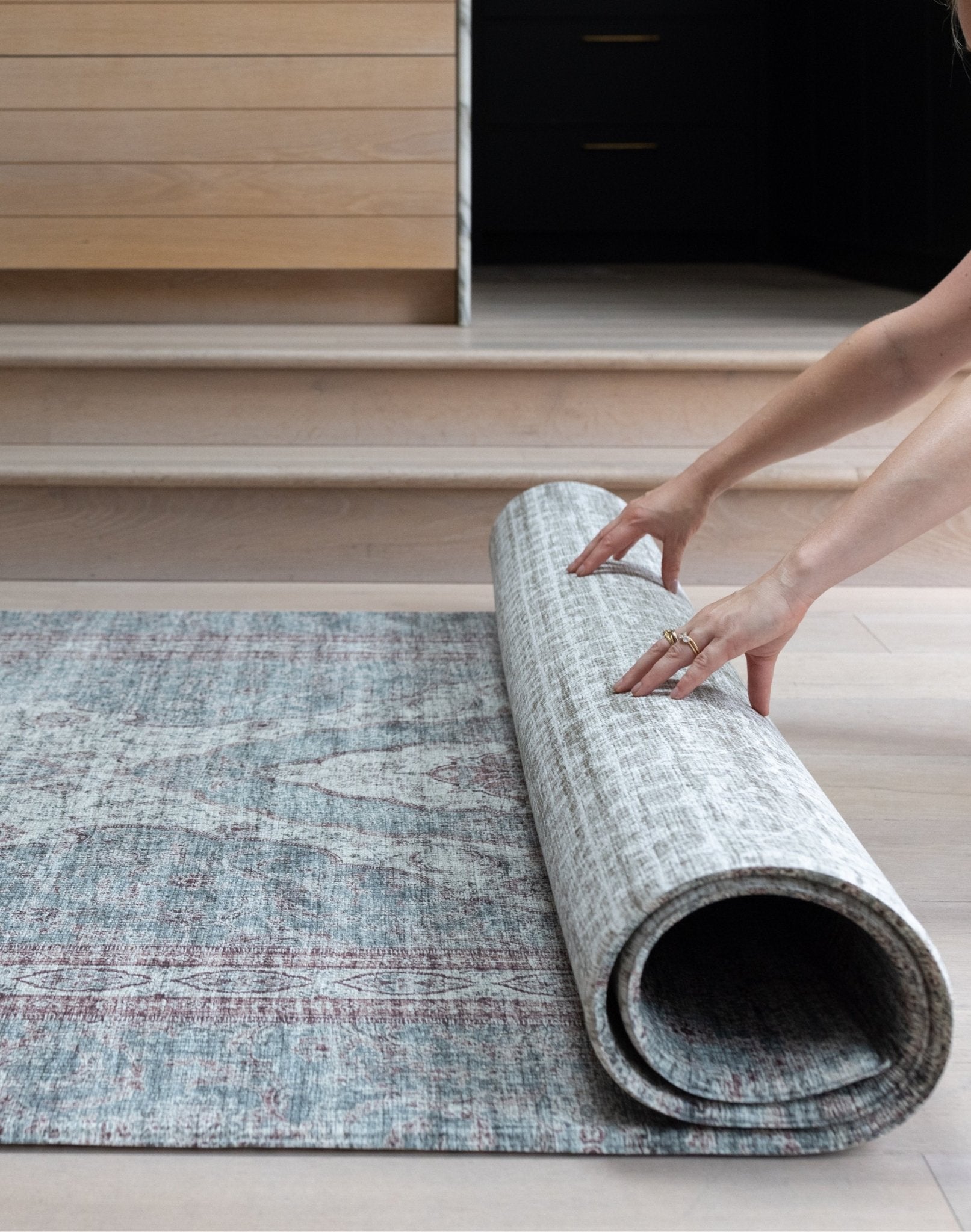 Rolling up a Totter & Tumble playmat to show flexible, easy to store design.