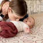 Mother bonding with baby on The Brecon, a UK-designed baby mat with soft tufted texture and calming earthy tones