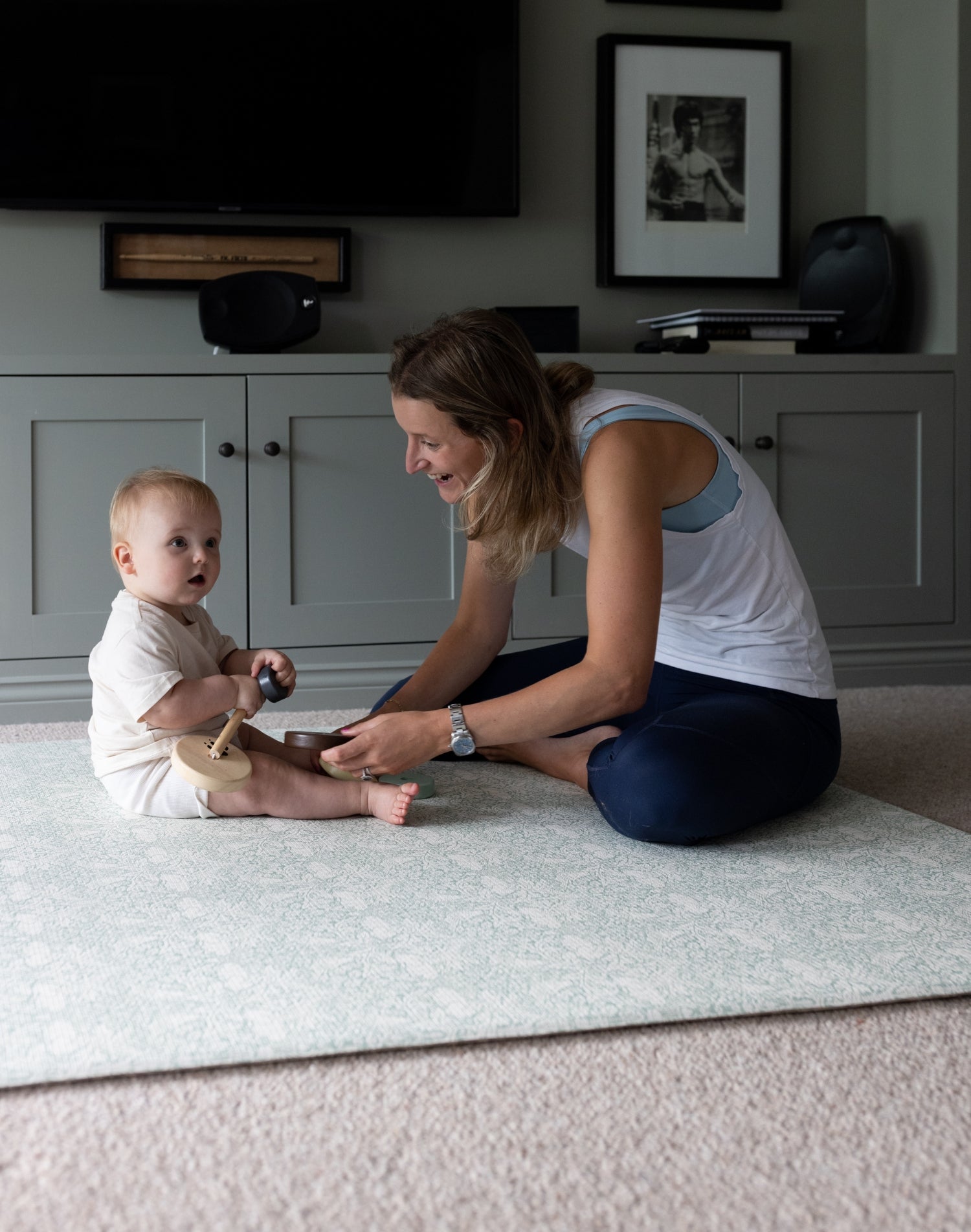 Parent engages with their baby on The Brer Rabbit Playmat, a durable and stylish play mat that complements modern classic interiors.
