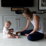 totter + tumble mom and baby playing on thick padded memory foam playmat in brer rabbit design 