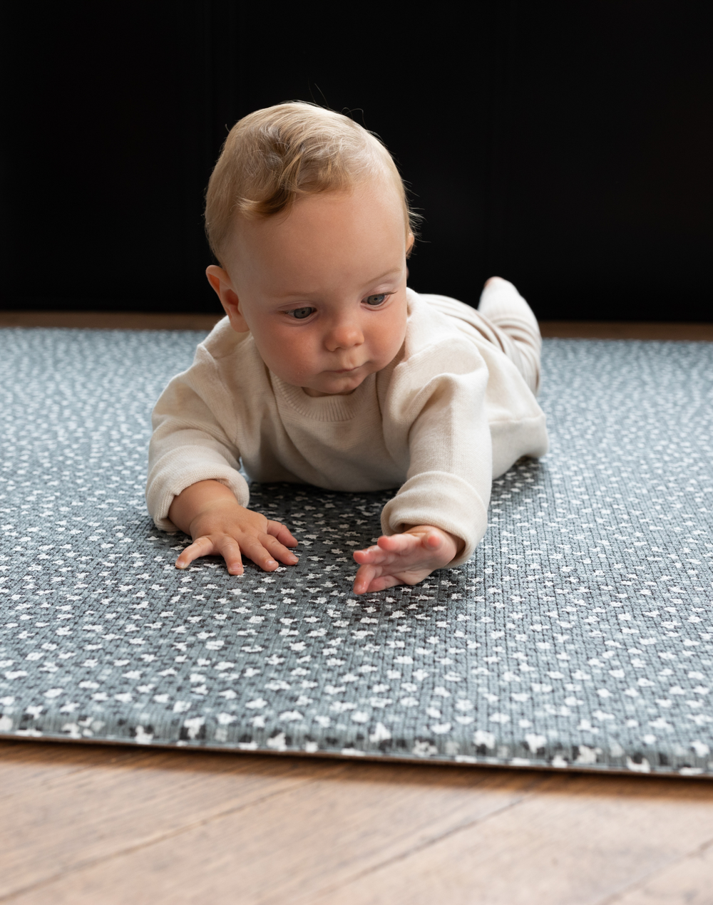 Baby enjoys tummy time on leopard print foam floor mat 