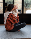 Lady and baby are protected on the thick padded floor mat by totter and tumble with a modern green design 