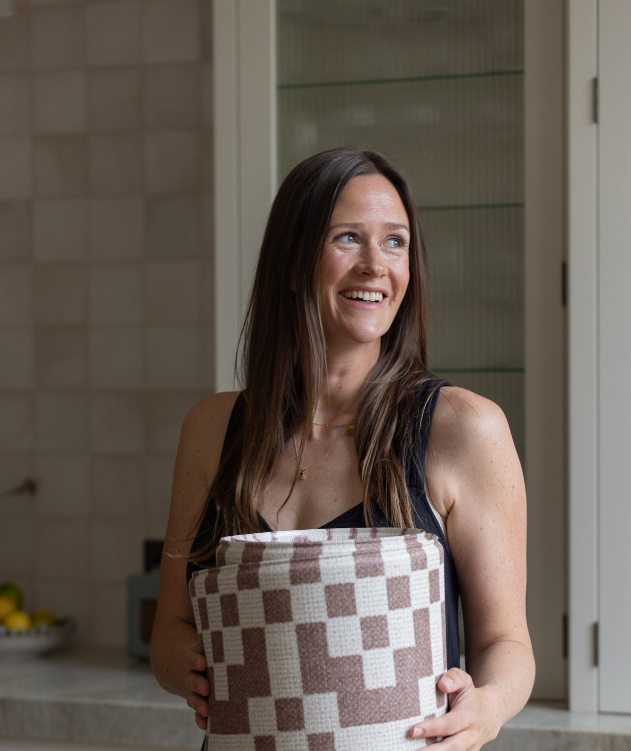 Totter + Tumble founder Susie holds a large baby playmat