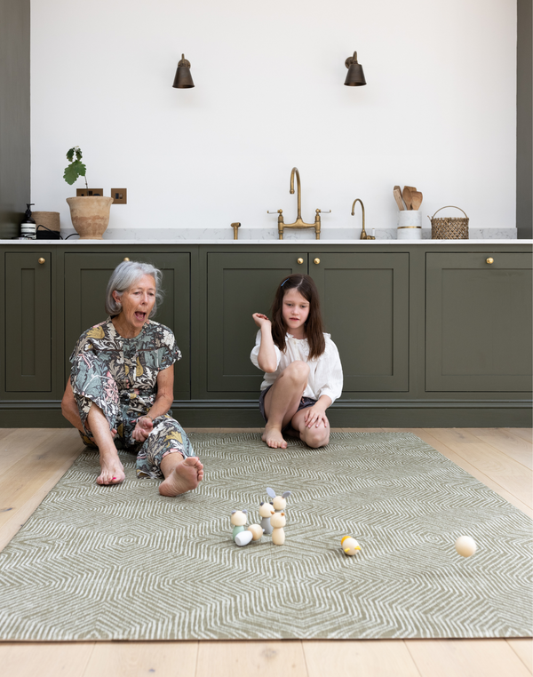 Lady and child enjoy play time together on the keuken mat in green tones to complement the kitchen 