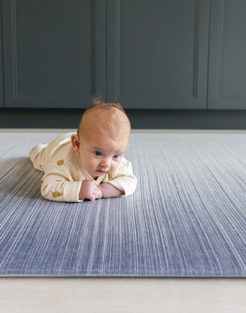 Baby enjoying tummy time on Baby play mats by Totter and Tumble are safe from birth and perfect for tummy time with mouldable memory foam to support little ones building strength 