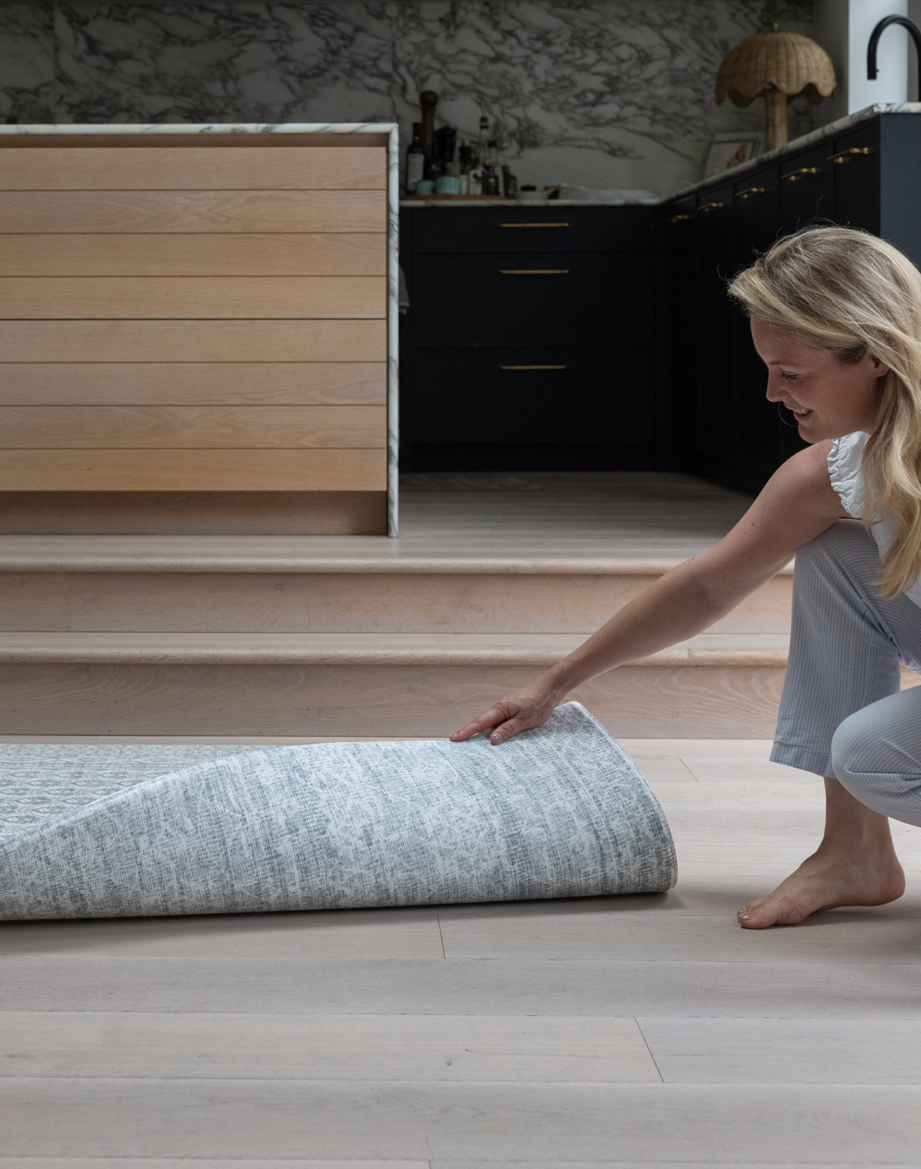 Unrolling a reversible playmat in a modern kitchen