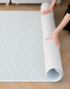 Placing the one piece play mat in place with a reversible design to complement modern interiors 