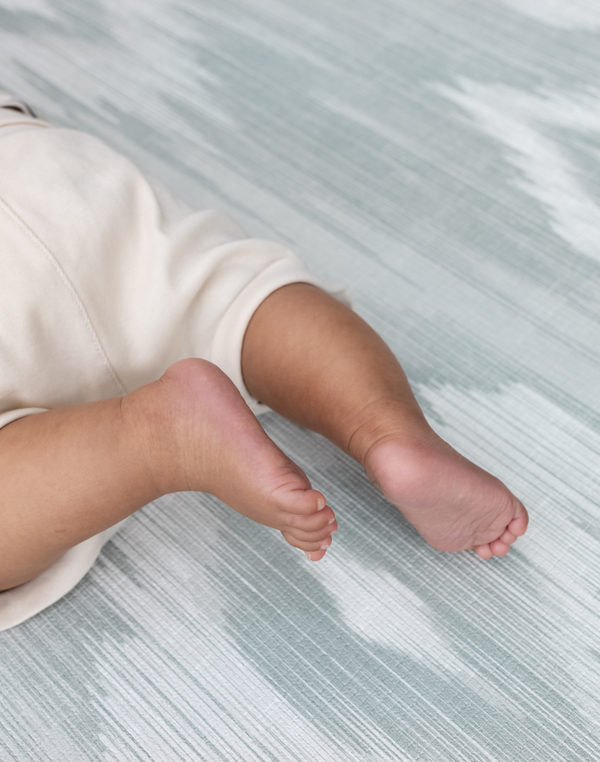 Close up of baby feet and design on Baby activity mat made from luxury memory foam to keep little ones comfortable on the floor