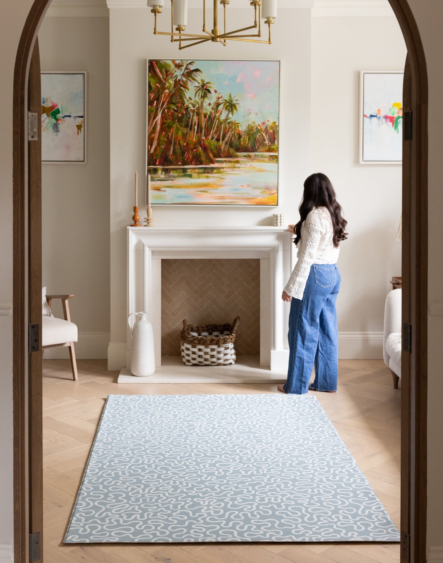 The Pembroke  handwoven style playmat styled in a modern living space, a UK-designed baby mat in soft blue.