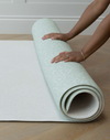 Unrolling the memory foam speelmat by Totter and Tumble with the subtle Rambler and Globe Trotter designs