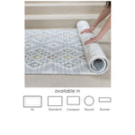 Person unrolling a patterned playmat 'The Rune and The Juniper' available in 5 sizes