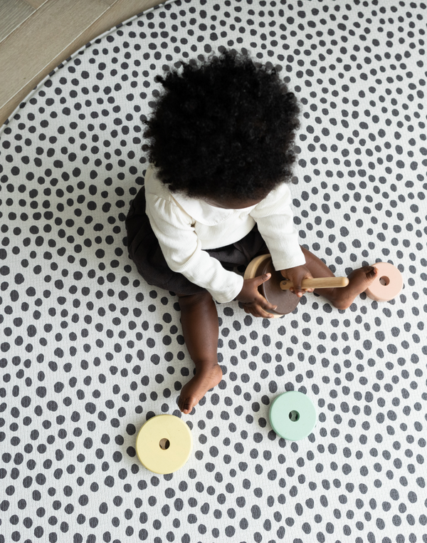 Baby explored wooden eco toy on the allergy friendly baby mat by totter and tumble 