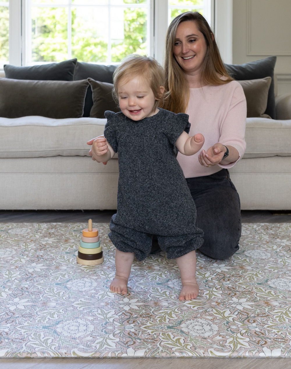 mum and baby playing on totter and tumble padded playmat foam play mat in morris & co heritage design severn, toddlers learning to walk on comfy padded playrug non slip textured surface easy to clean and wipedown washable play mat one piece and reversible to suit your family home