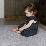Toddler enjoys play time on the thick large play mat by totter and tumble the leopard print play mat design in subtle grey is beautiful for the family home with memory foam for protection on hard tile and wood flooring