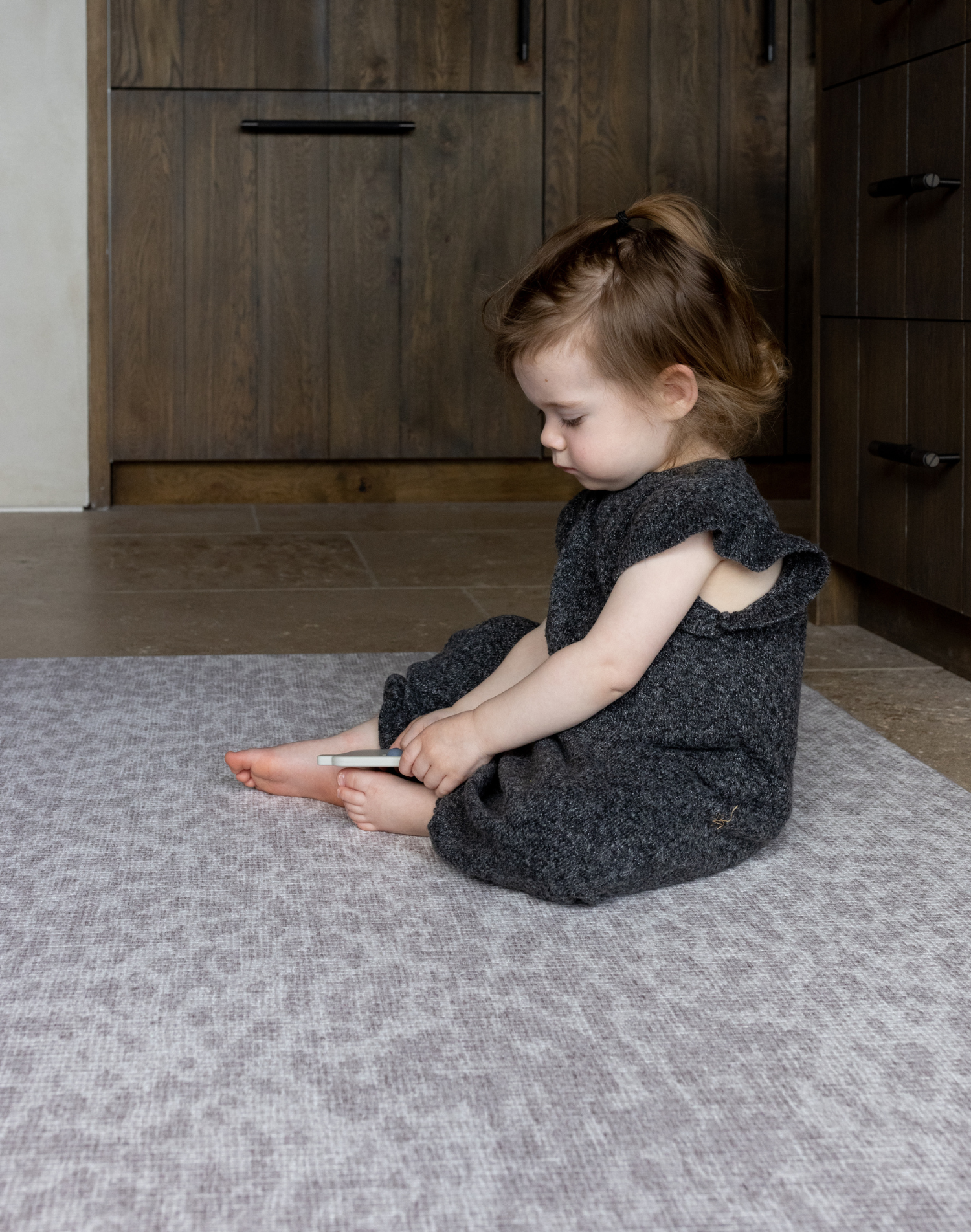 Toddler enjoys play time on the thick large play mat by totter and tumble the leopard print play mat design in subtle grey is beautiful for the family home with memory foam for protection on hard tile and wood flooring