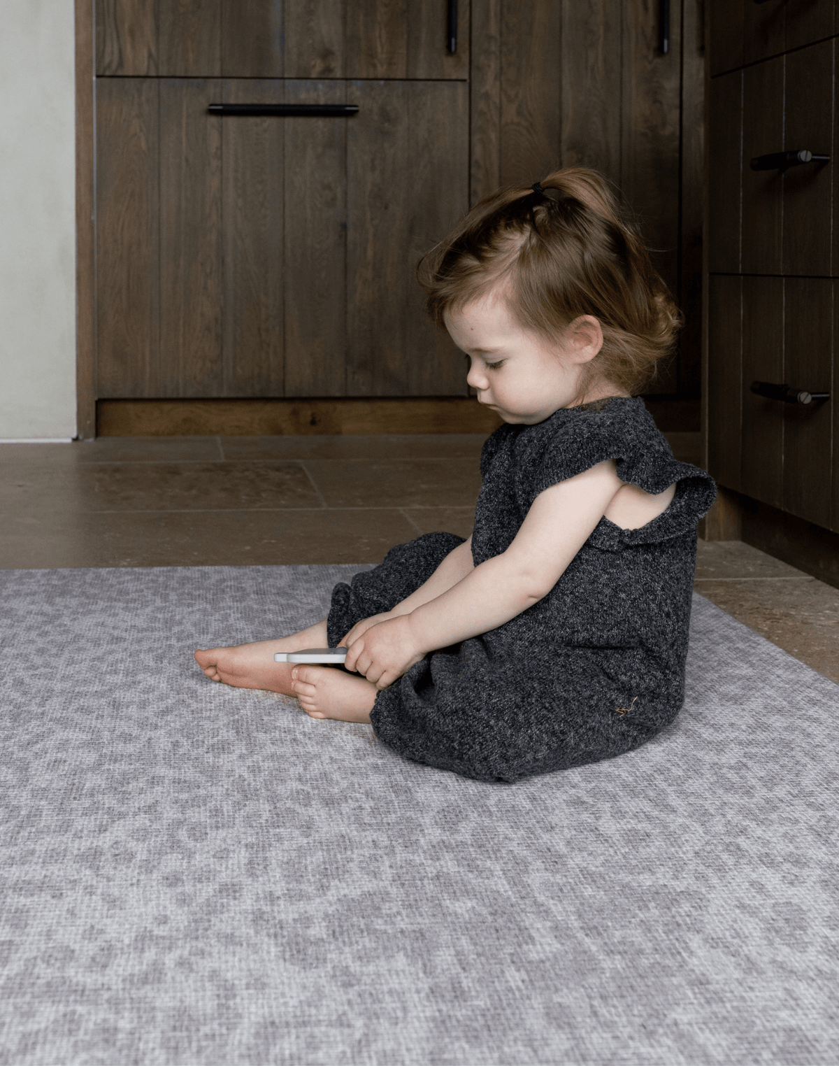 Toddler enjoys play time on the thick large play mat by totter and tumble the leopard print play mat design in subtle grey is beautiful for the family home with memory foam for protection on hard tile and wood flooring