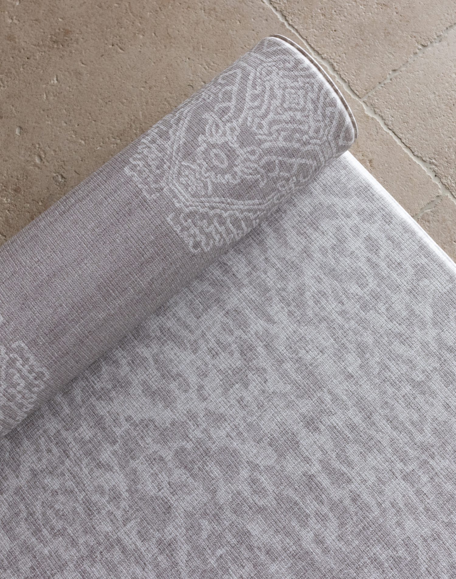 Close up of the double sided grey playmat with two textural designs to look good in modern family homes luxury memory foam provides protection for the family on the floor enjoying playtime and exercise