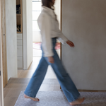 lady walks across the sealed memory foam hallway runner thick and comfortable to keep the household supported and to keep feet off cold flooring versatile mat design ideal as a kitchen mat large bathroom mat and padded exercise mat