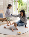 Mother and children on Round play mat for hard floors by Totter and Tumble so little ones don't feel the floor underneath with stylish tan and cream design for a stylish look 