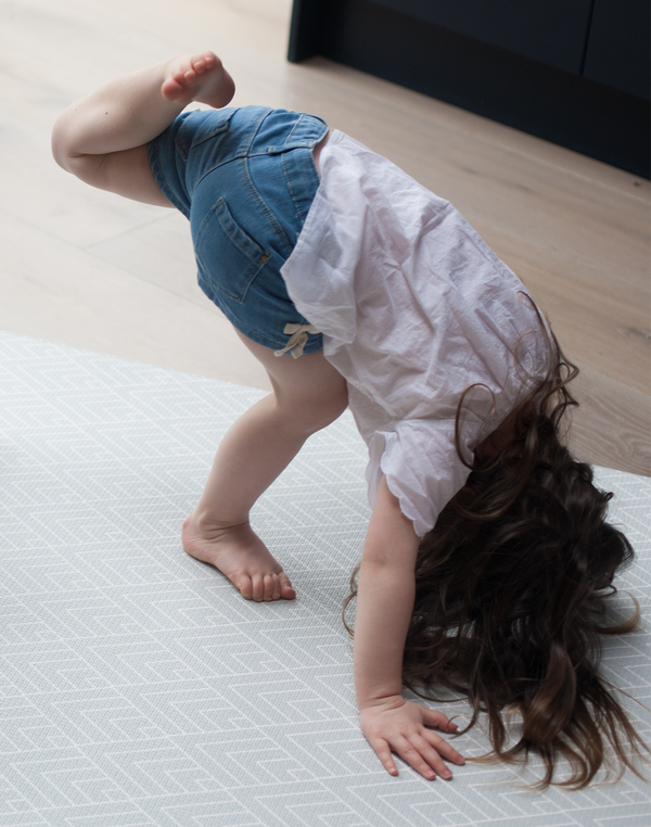 Little girl exercises on large non-slip play mat 