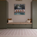 Room interior with the Totter + Tumble Weaver crawling mat for babies. A heritage-inspired playmat in earthy brown red tones.