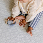A baby sat comfortably on the thick memory foam beachcomber playmat | SKU: 26 BEACH/GATHER XL, 26 BEACH/GATHER STD, 26 BEACH/GATHER COMP