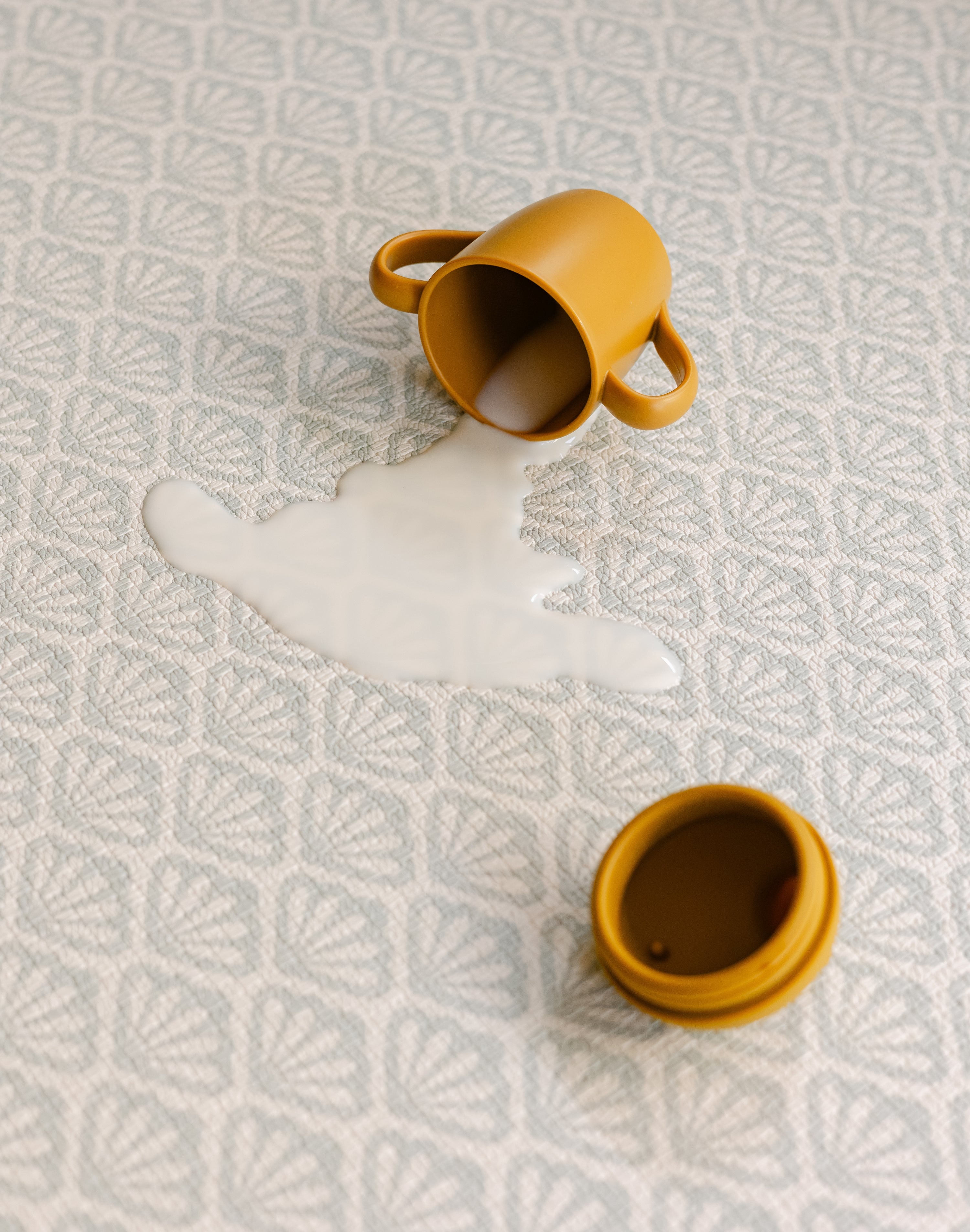 Spilt milk on the easy to clean wipeable beachcomber coastal rug-like playmat from totter and tumble | SKU: 26 BEACH/GATHER XL, 26 BEACH/GATHER STD, 26 BEACH/GATHER COMP