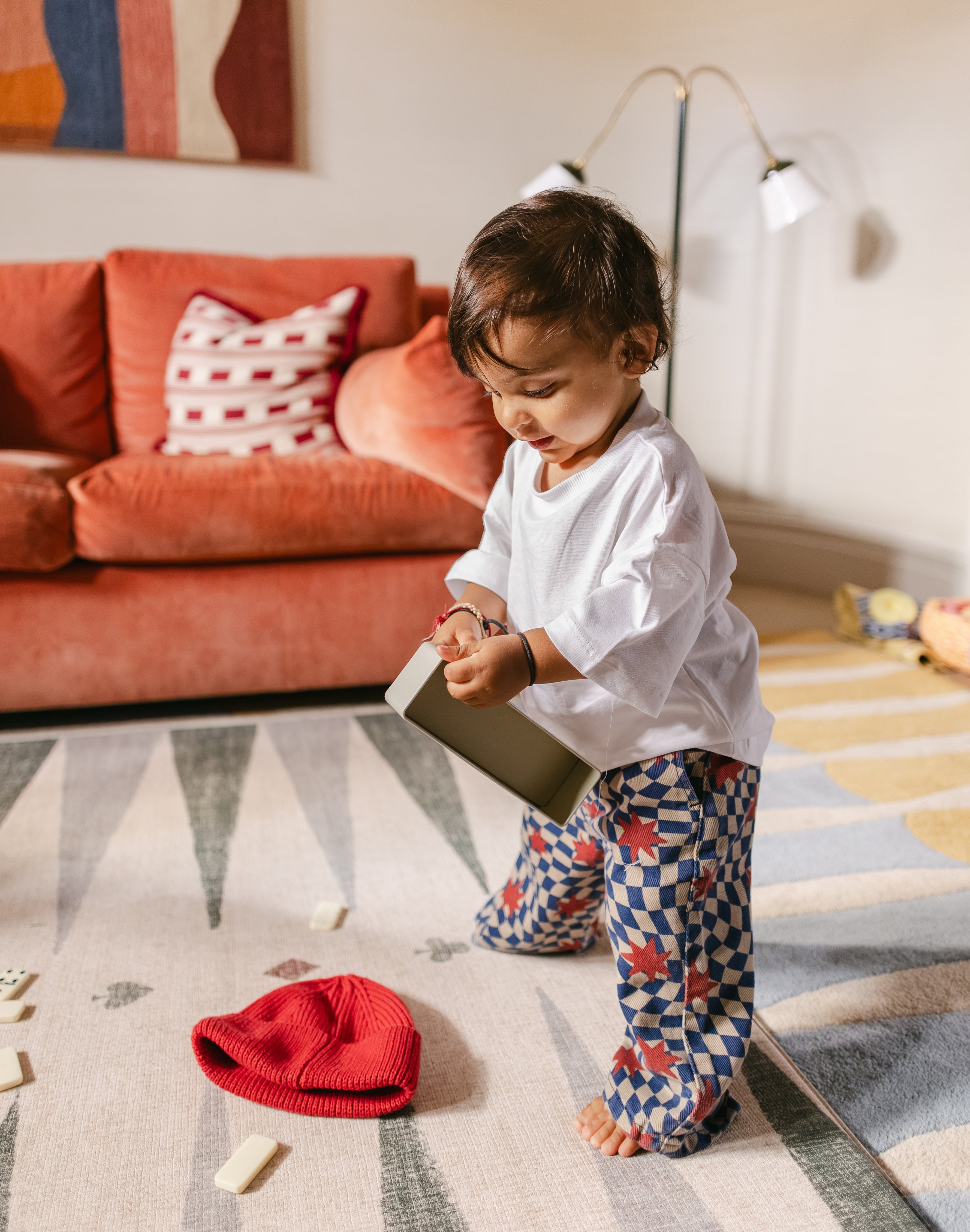 Child playing on The Counter wipeable reversible memory foam playmat from Totter + Tumble