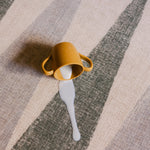 Milk spilled on The Counter reversible memory foam playmat from Totter + Tumble