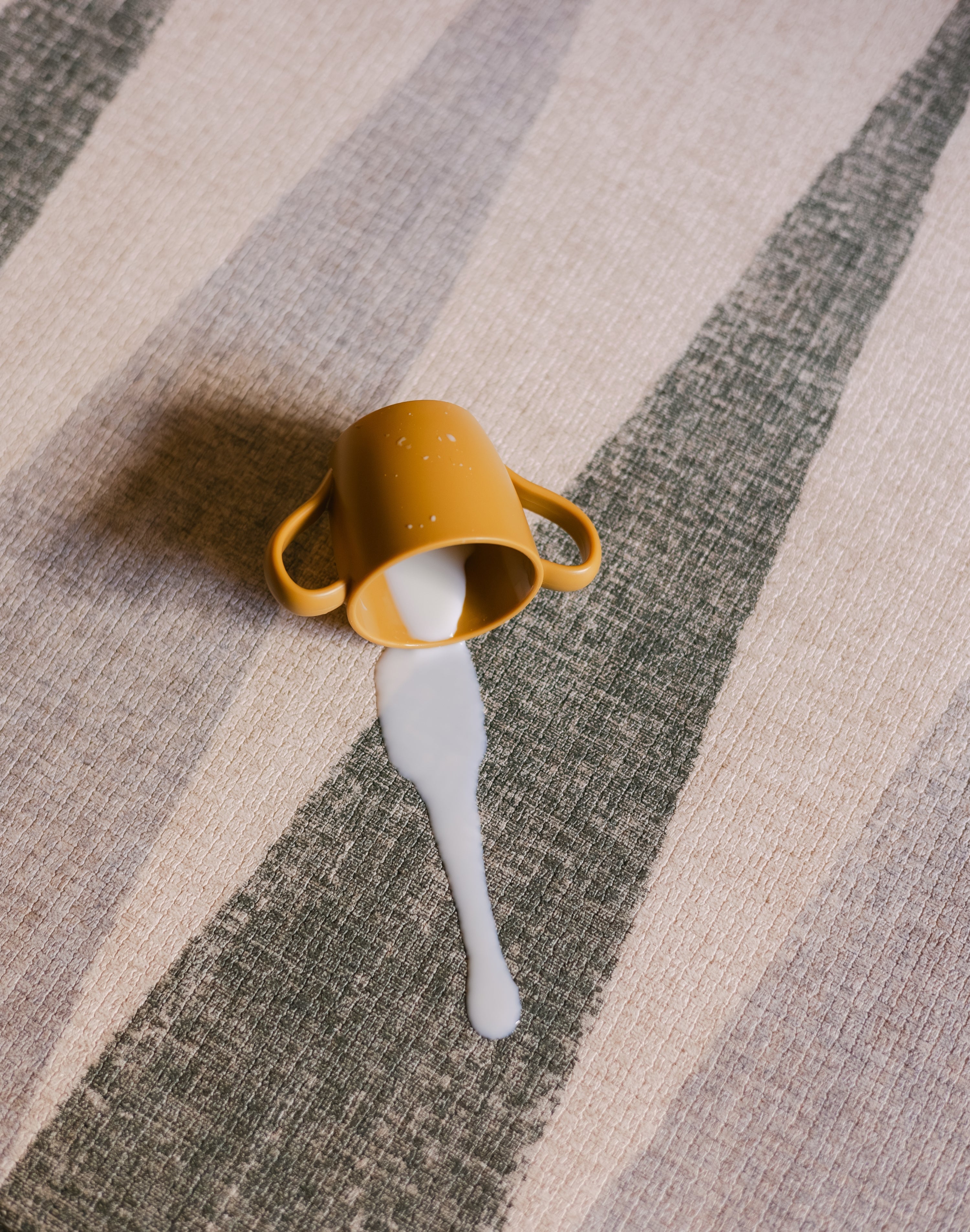 Milk spilled on The Counter reversible memory foam playmat from Totter + Tumble