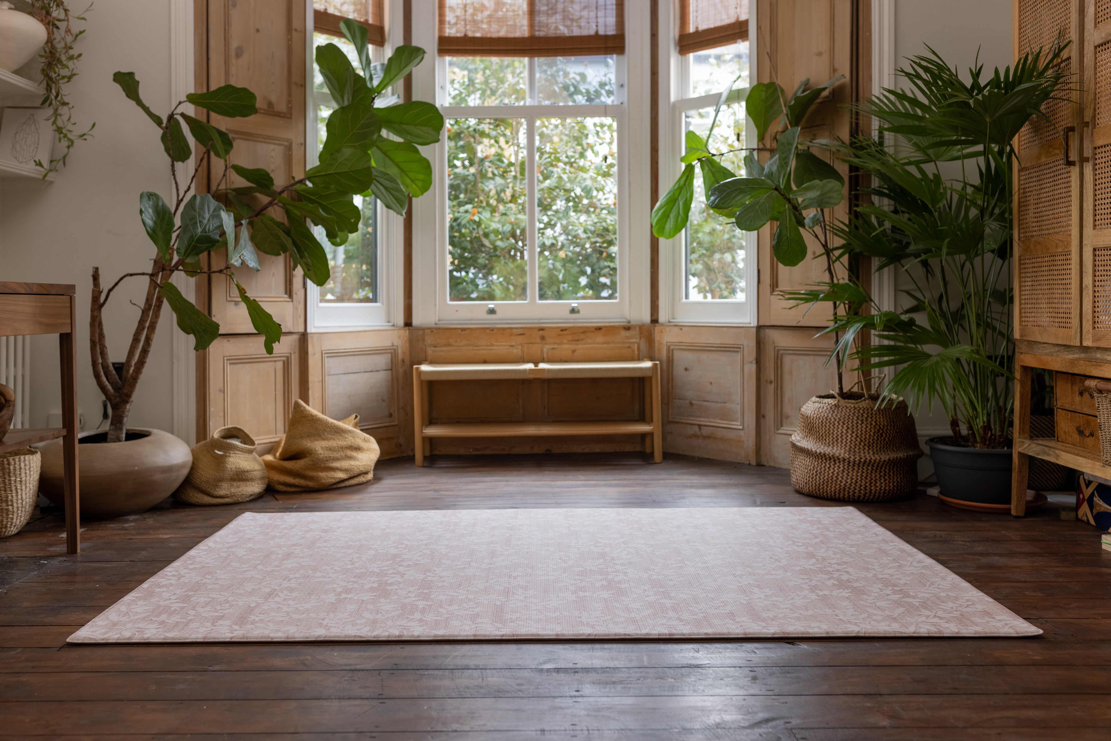pink floral large rug-like totter and tumble playmat in a living room