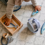 A baby playing with toys on a rug-like, supportive, totter and tumble memory foam playmat | SKU: 26 BEACH/GATHER XL, 26 BEACH/GATHER STD, 26 BEACH/GATHER COMP