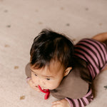 Tummy time on The Wildcard XL reversible memory foam playmat by Totter + Tumble, the largest one piece playmat on the market