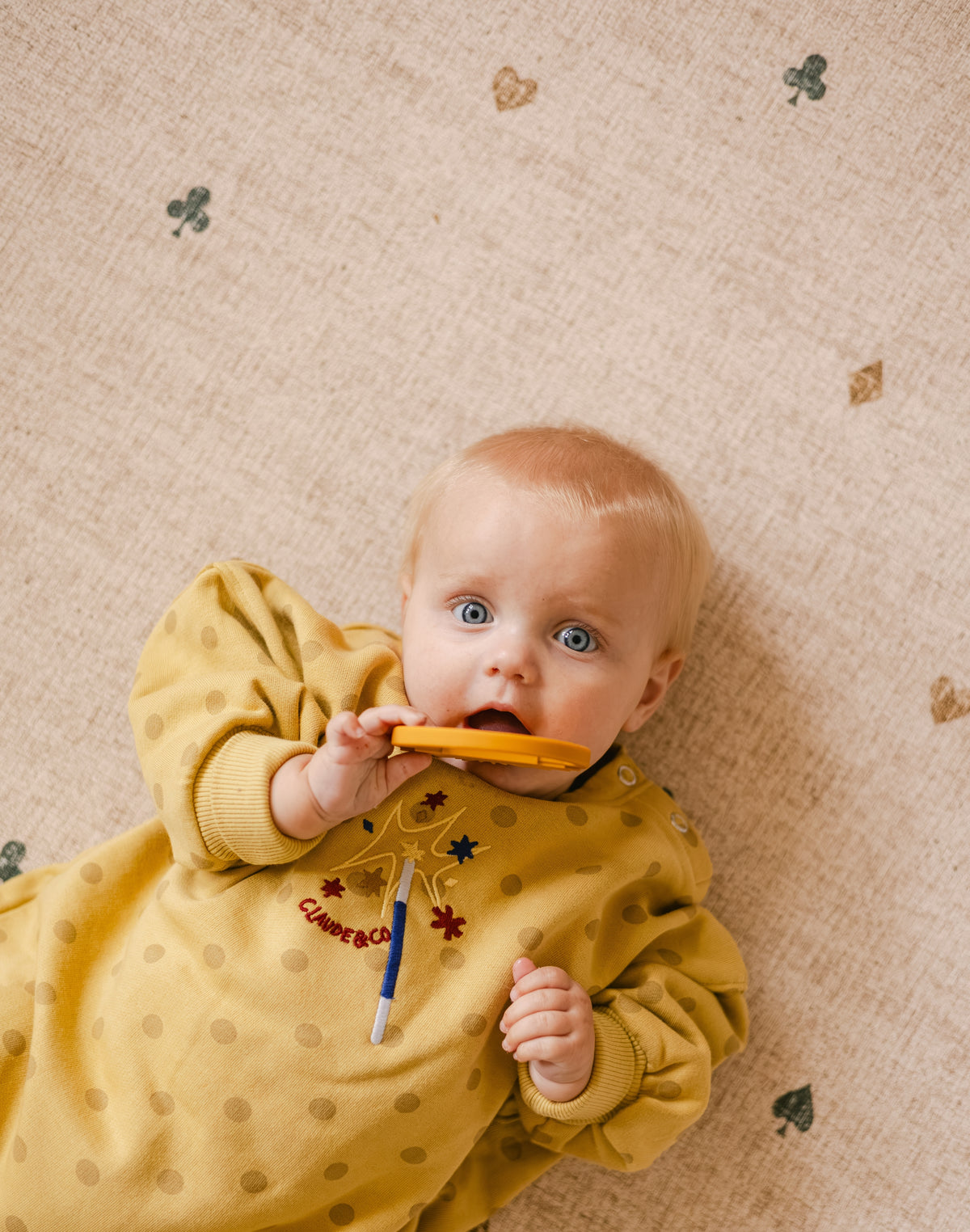 Baby lying on The Wildcard Totter + Tumble reversible memory foam playmat