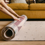 The Wildcard XL reversible memory foam playmat by Totter + Tumble, the largest one piece playmat on the market, rolled into The Roller